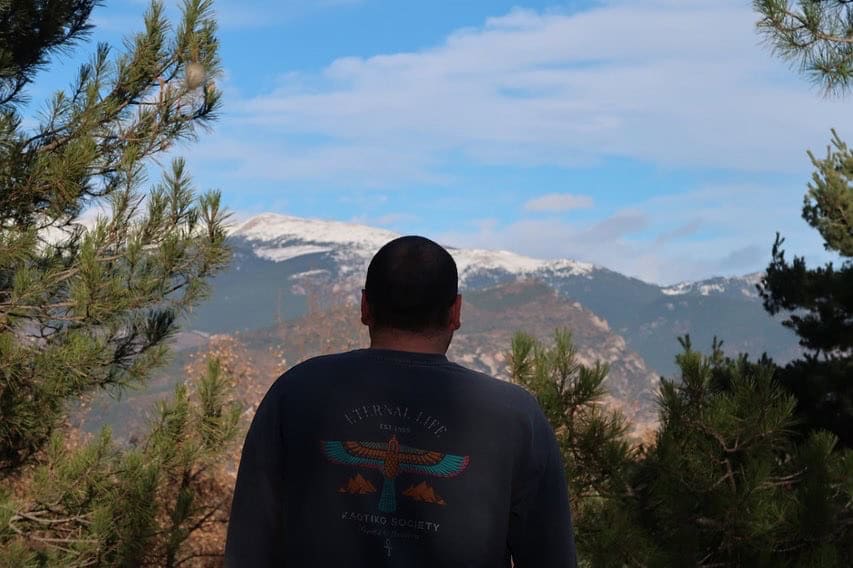 Person gazing at the Pyrenees mountain landscape.
