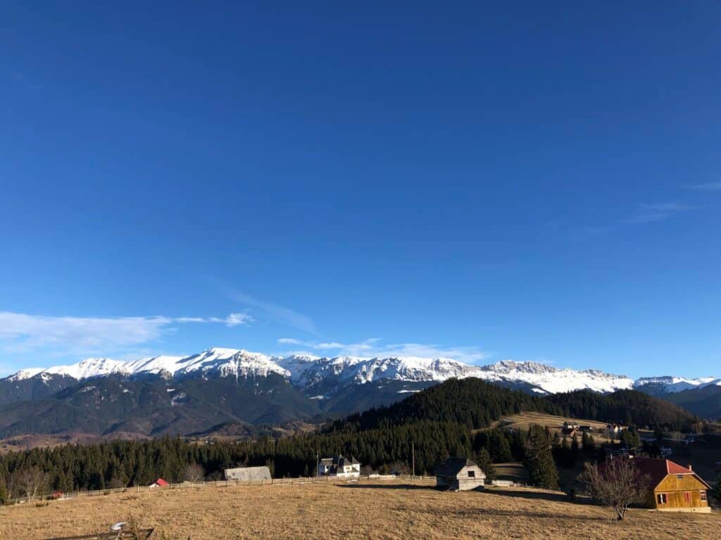 Romania Travel Guides 2 Snow-capped Carpathian mountains under a blue sky in Romania